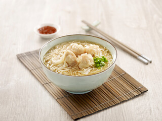 Signature Canton Jumbo Prawn Wanton Noodle with chopsticks served in a bowl isolated on mat side view on grey background