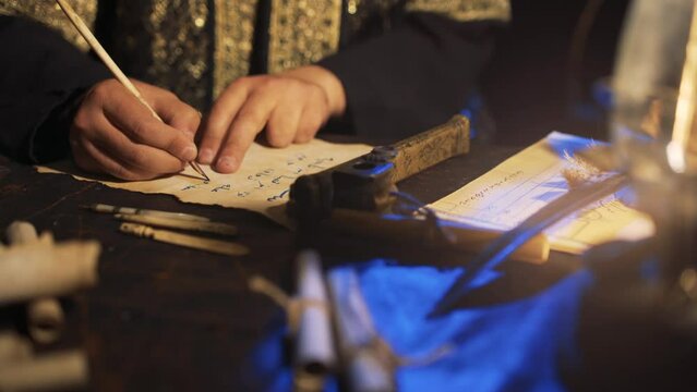 The man who wrote the edict in Arabic in ancient times. Ottoman period clerk. Sword, pen, paper, ink. Writing by candlelight.
