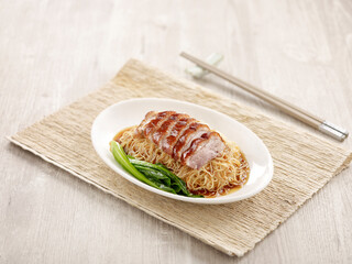Crispy Roasted Irish Fat Duck Noodle with chopsticks served in a dish isolated on mat side view on grey background