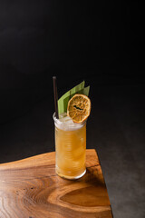 Tropical yellow cocktail garnished with orange. Bar concept