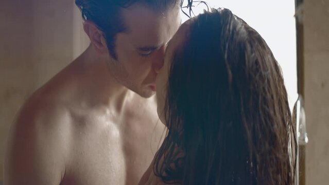 A couple in a intimal moment. Action. Naked man looking into the eyes of his lover with passion.