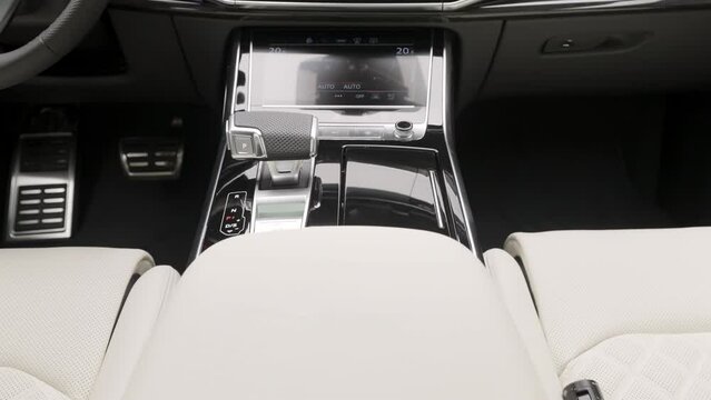 Close-up of modern interior design of car. Action. Salon of latest model of expensive car. Expensive interior with display of new car model