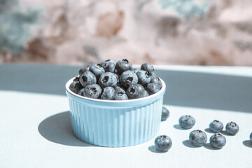 Blue blueberry berries in bowl on the table on the kitchen, organic food