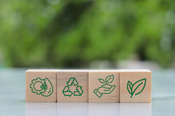 green and recycle icon concept on horizontal wooden cube on table