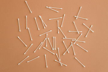 top view of ear sticks on beige background with copy space.