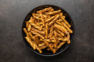 Salted pretzel sticks. Salted crackers in plate.