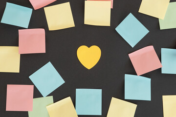 Colorful sticky notes on black background. Space for text