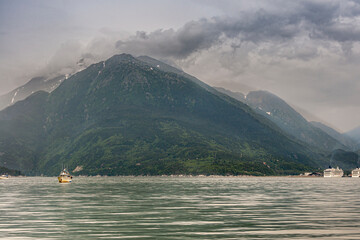 Skagway, Alaska, USA - July 20, 2011: Taiya Inlet above Chilkoot Inlet. Green forested mountains...