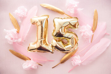 Happy fifteenth birthday with golden number fifteen 15 air balloons and feathers with colorful decorations on pink