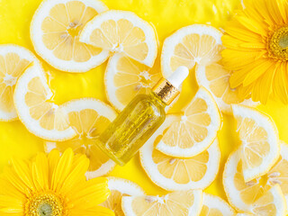 Essential oil, serum on textured background with yellow lemon slice - 511129487
