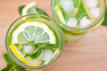 Refreshing summer mojito cocktail or lemonade drink with lemon, mint and ice ingredient from the top view