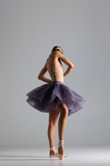 young beautiful ballet dancer posing in a studio