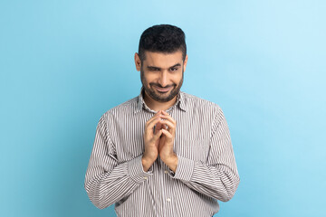 Portrait of funny tricky handsome businessman thinking devious plan with cunning face expression,...