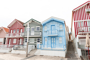 Brightly colored creative houses with striped coloring in a fishing village near the ocean in Portugal