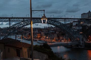 Obraz premium Vintage antique european night town of Porto with beautiful streets, bridge, lantern and lights