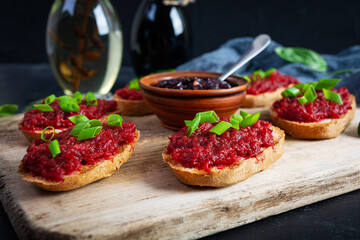 Bruschetta with grated beetroot, herbs and caramelized onion