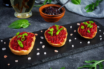 Bruschetta with grated beetroot, herbs and caramelized onion