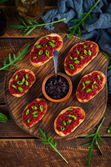Obraz na płótnie Canvas Bruschetta with grated beetroot, herbs and caramelized onion. Top view