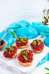 Bruschetta with grated beetroot, herbs and caramelized onion