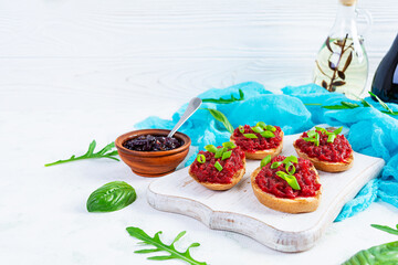 Bruschetta with grated beetroot, herbs and caramelized onion