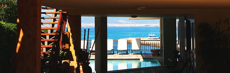 Panoramic sea view. Balcony with pool illuminated by bright sun, Mallorca, Spain