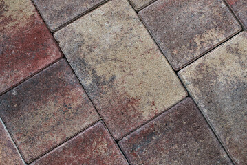 Texture of colored cobblestones for backgrounds. Concrete pavement on the sidewalk
