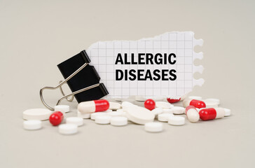 Among the tablets and capsules is a clip with paper on which is written - Allergic diseases