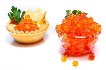 Beautiful red caviar in small glass bowl with parsley on top. Caviar in tartlet with butter and parsley on white background.