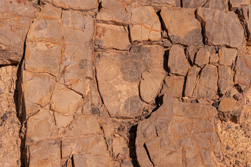 Textured stone background of sand color with natural scratches and patterns. Stone wall.