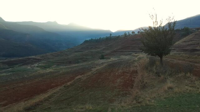 Lesotho mountains by sunrise Lesotho farmhouse 
rural Lesotho