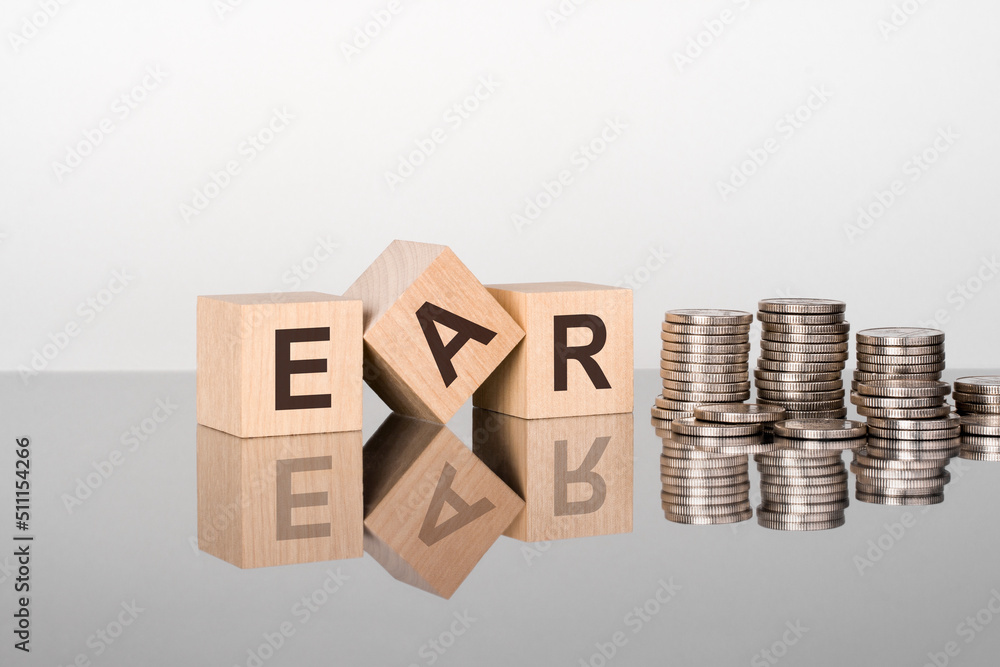 Fototapete ear - text is made up of letters on wooden cubes lying on a mirror surface