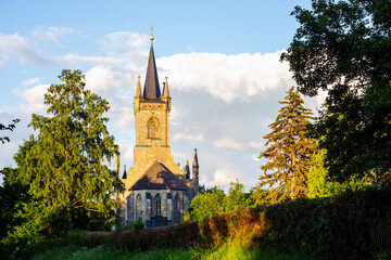 small church with trees and cloudy sky