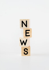 Cubic wooden blocks forming the 'news' text