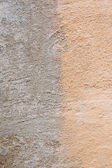 Background, texture of a cracked, stained beige, gray wall.