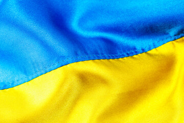 Fabric curved flag of Ukraine, UA. Blue and yellow colors.Ukrainian passport.Stop war.Patriotism.Concept of Ukraine.Democracy and politics. Close up shot, background