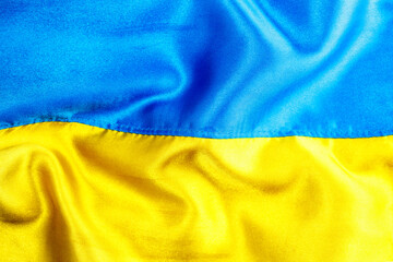 Fabric curved flag of Ukraine, UA. Blue and yellow colors.Ukrainian passport.Stop war.Patriotism.Concept of Ukraine.Democracy and politics. Close up shot, background
