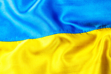 Fabric curved flag of Ukraine, UA. Blue and yellow colors.Ukrainian passport.Stop war.Patriotism.Concept of Ukraine.Democracy and politics. Close up shot, background