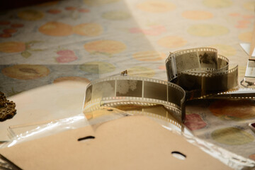 close up of a film negative analogue photo in the afternoon golden hour on a table	
