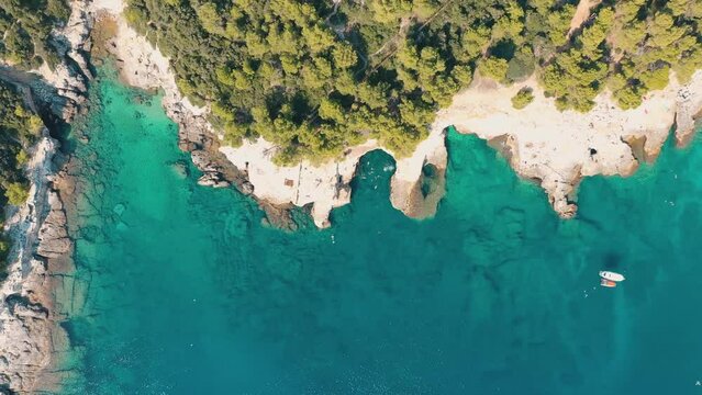 Galebijana Cave Pula, Croatia. Сave in the sea with blue water. Dorone flight over the sea. People swim in blue water.