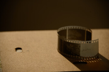 close up of a film negative analogue photo in the afternoon golden hour on a table	