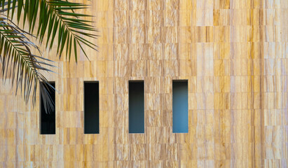 Abstract exterior architecture facade of  a modern yellow residential  building with openings and...