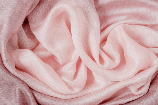 Textile texture, abstract background, spiral wavy lines, various shades of pink color