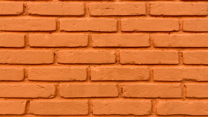 Wall covered with rectangular bricks painted in pumpkin color