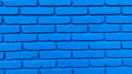 Wall covered with rectangular bricks painted in blue color