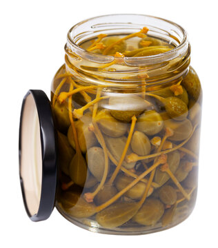 Canned green capers in a glass jar. Isolated over white background
