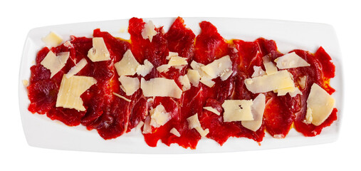 Carpaccio and cheese served on plate. Dish made of raw beef meat. Isolated on white background