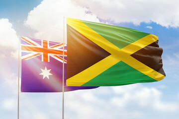 Sunny blue sky and flags of jamaica and australia