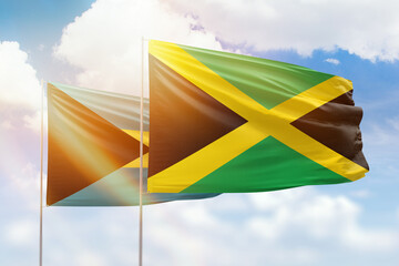 Sunny blue sky and flags of jamaica and bahamas