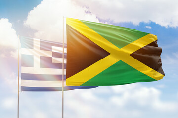 Sunny blue sky and flags of jamaica and greece