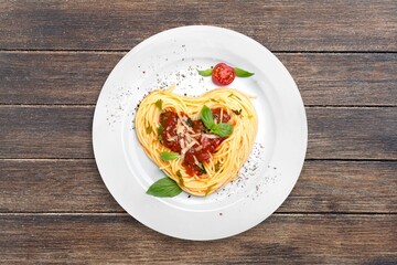 Noodles with parmesan in cream sauce in a white plate on the kitchen table. Traditional Italian pasta on a light culinary background.